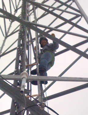 Ashleigh climbing utility tower for an inspection during HSE auditing